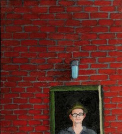 Brick wall with a portrait of a white man with glasses and a hat