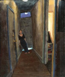 Clothed woman leaning on wall in a hallway